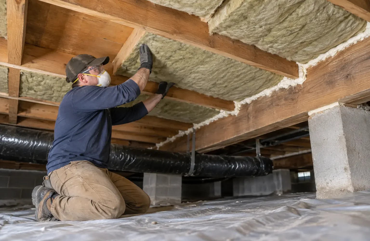 Mineral wool fitted between joists below an exposed floor