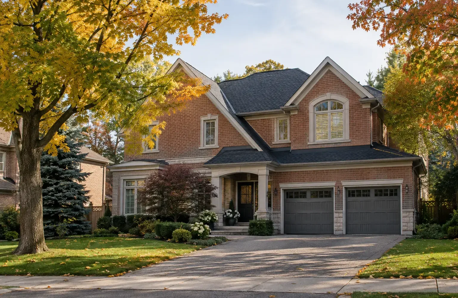 Detached brick home on a tree-lined Oakville street